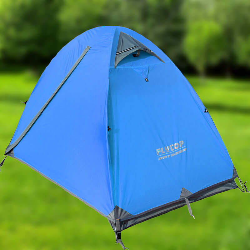Blue outdoor camping tent in nature, designed for rainproof and ultra-light high mountain adventures.