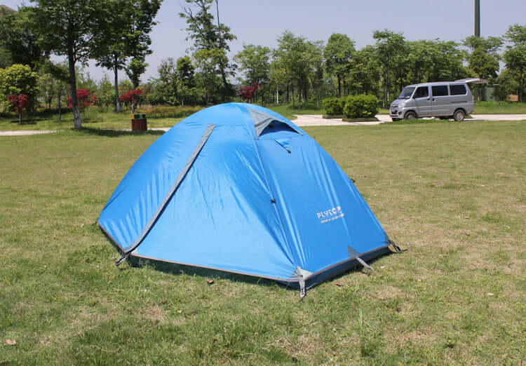 Durable blue outdoor camping tent on grass, ideal for high mountain snowfield and rainproof conditions.