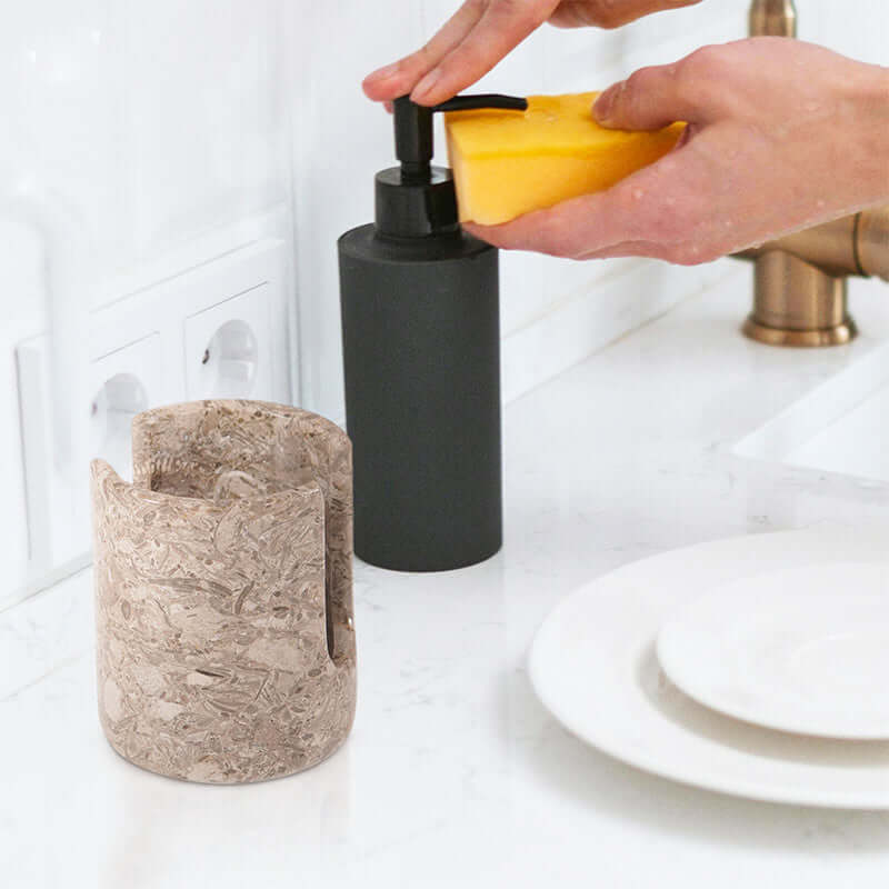 Stylish 3.5” natural marble sponge holder beside a soap dispenser, enhancing kitchen sink organization and decor.