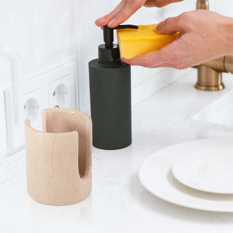 3.5" marble sponge holder next to soap dispenser, keeping sponges organized at kitchen sink.