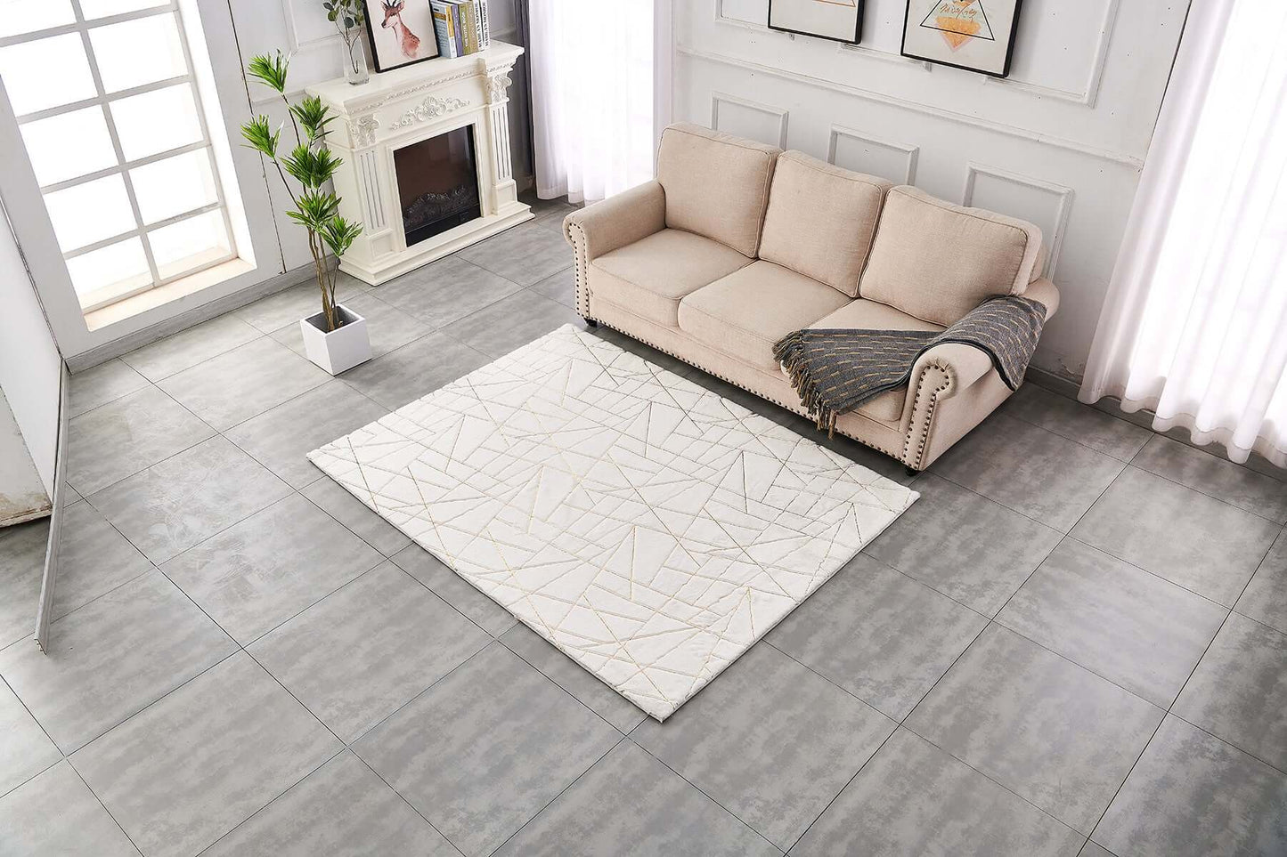 Stylish 3' x 5' white and gold abstract shag area rug in modern living room setting.
