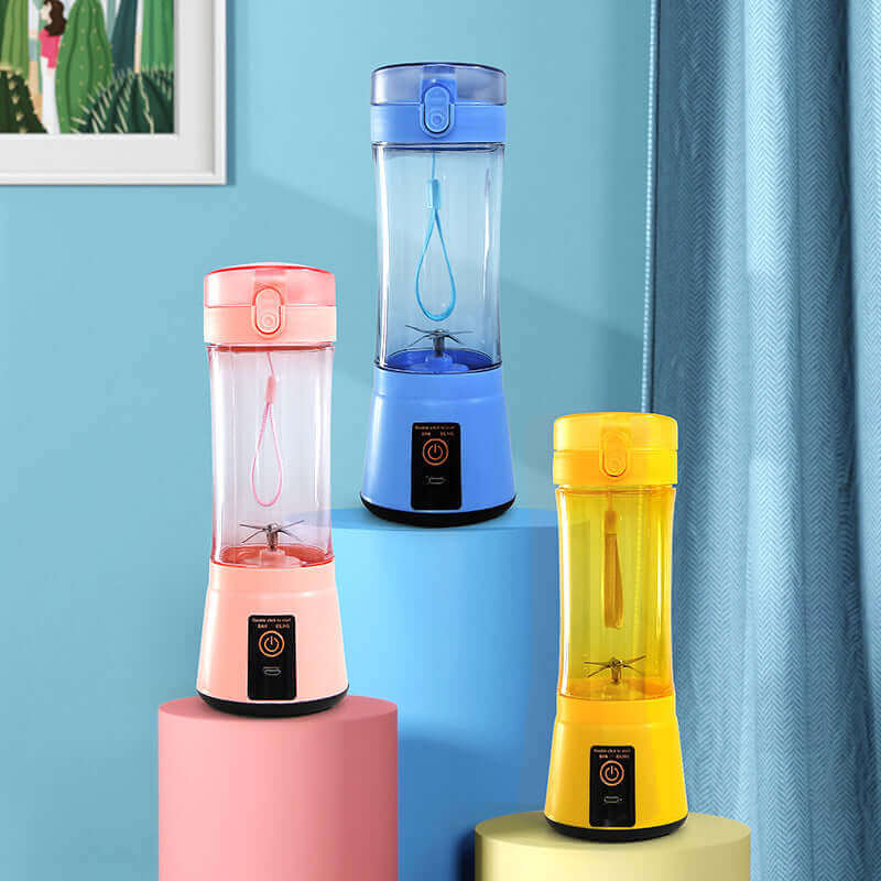 Portable electric fruit juicer in pink, blue, and yellow colors on display, ideal for smoothies and easy blending.