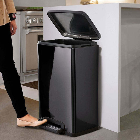 Stylish stainless steel 13-gallon kitchen trash can with step lid in charcoal black finish, located in modern kitchen.