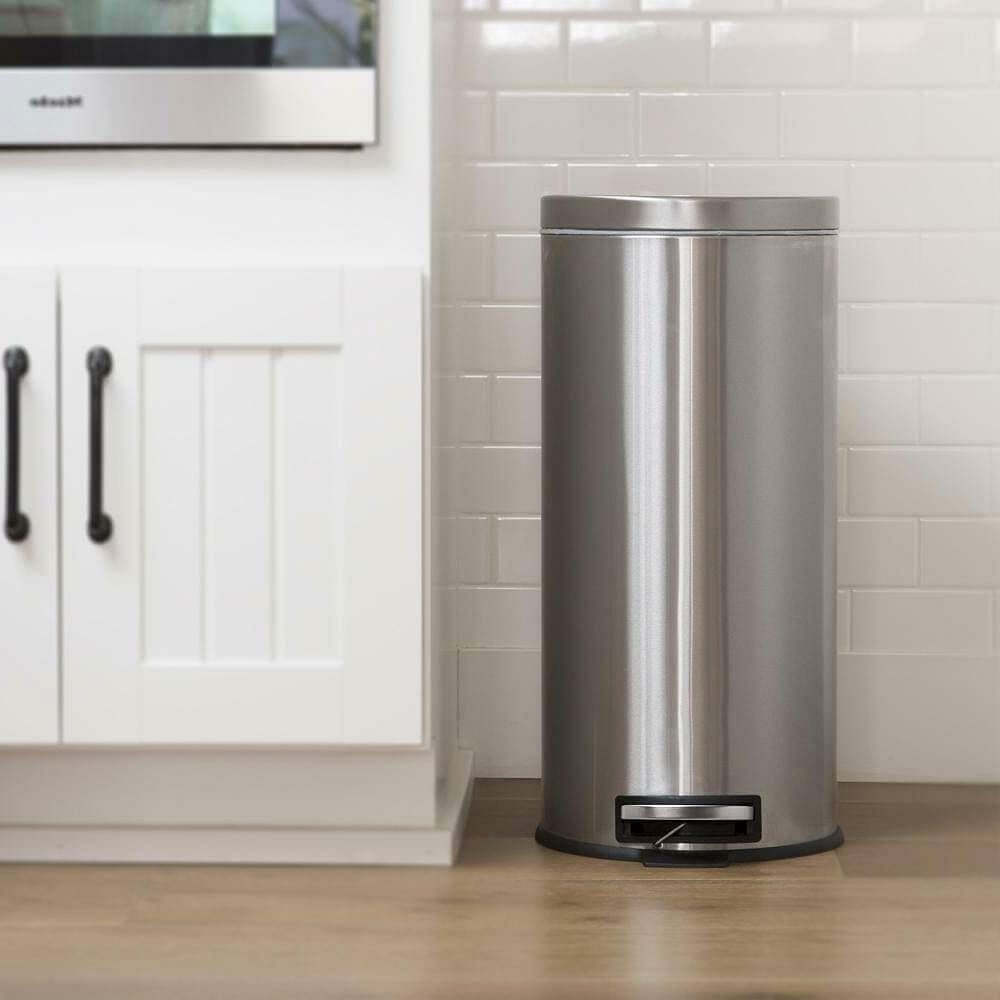 8-gallon round stainless steel step trash can in kitchen setting, designed for discreet waste disposal in home or office.