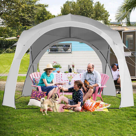 Family enjoying time under an 11x11 feet portable beach sun shade tent in a backyard setting.